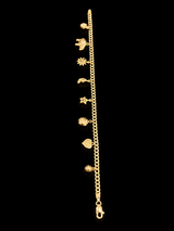 14k yellow gold charm bracelet with heart, elephant, sun and moon charms on black background — True Smith Jewelers Miami